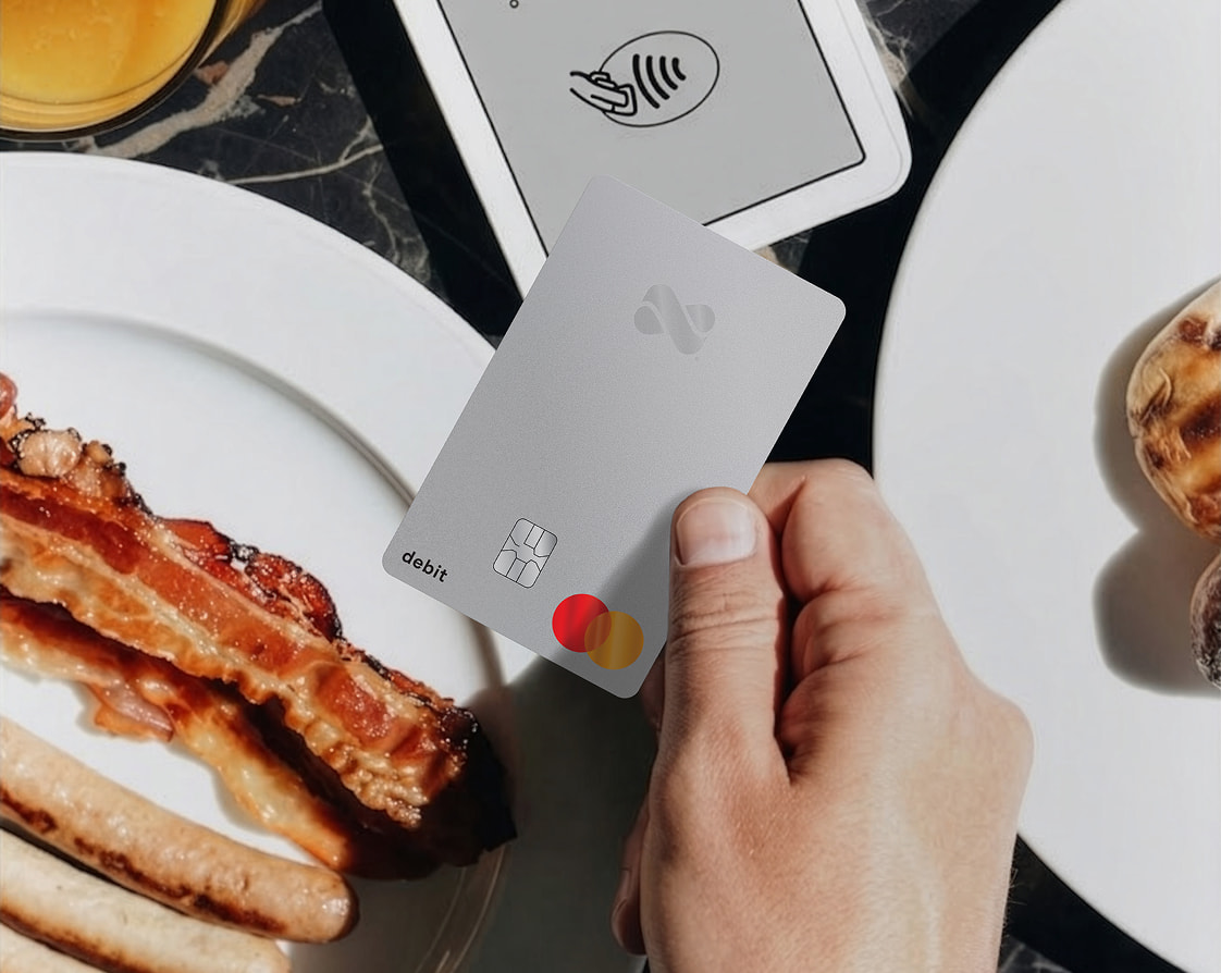 Tapping to pay for a brunch meal with a Netspend Debit Mastercard