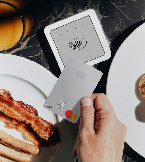 Tapping to pay for a brunch meal with a Netspend Debit Mastercard