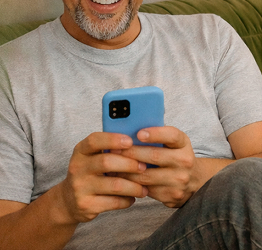Man looking at ihs phone on the couch