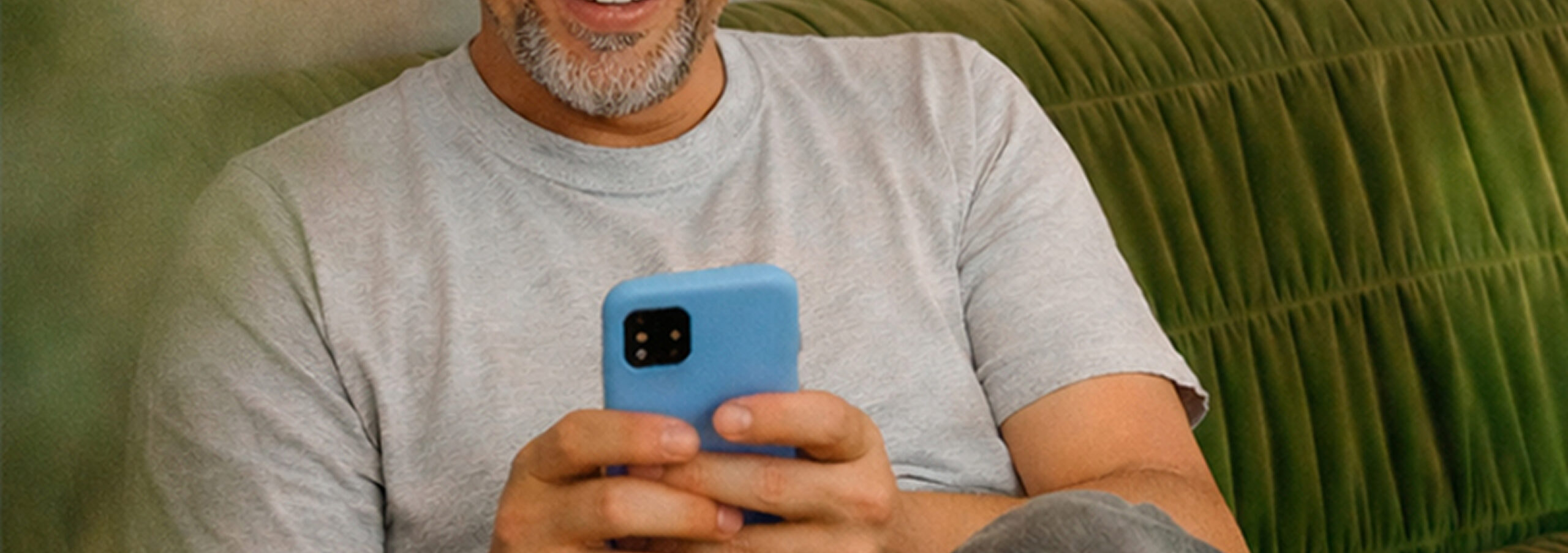 Man looking at ihs phone on the couch