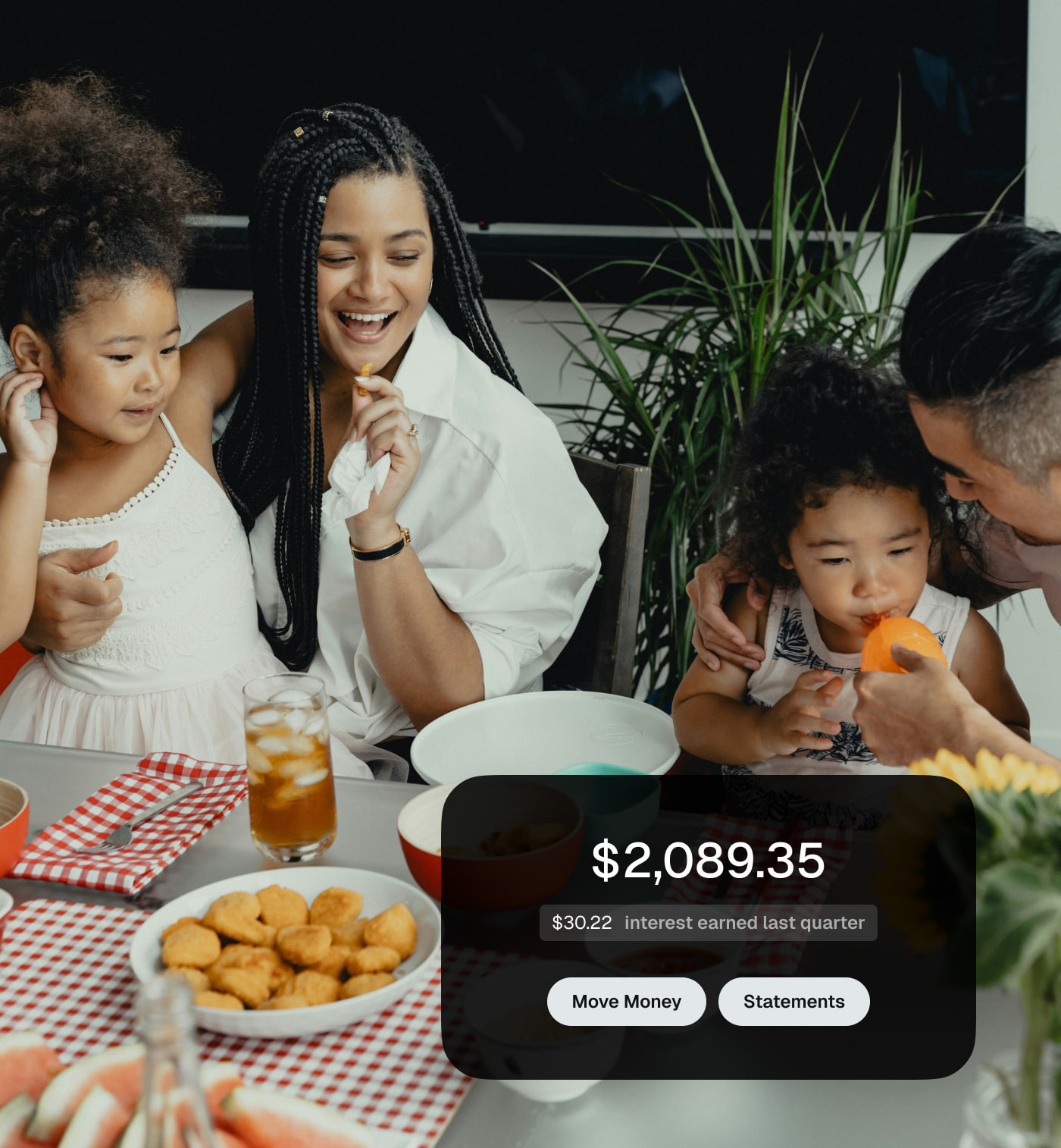 Family at dinner with a notification showing interest earned.