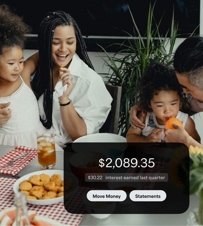 Family at dinner with a notification showing interest earned.